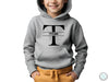 a young boy wearing a grey hoodie with the letter t on it