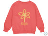 a pink sweatshirt with a yellow flower on it